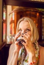 Beautiful girl drinking beer from the glass cup. Royalty Free Stock Photo