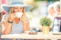 Beautiful girl drinking coffee in a cafe terrace. Summer portrait young woman Royalty Free Stock Photo