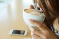 Beautiful girl drinking hot coffee or tea in coffee cafe Royalty Free Stock Photo