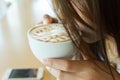 Beautiful girl drinking hot coffee or tea in coffee cafe Royalty Free Stock Photo