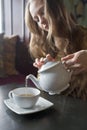 Beautiful Girl Drinking Tea or Coffee in Cafe Royalty Free Stock Photo