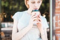 Beautiful Girl Drinking Tea or Coffee. Cup of Hot Beverage Royalty Free Stock Photo