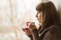 Beautiful girl drinking Tea near Window Royalty Free Stock Photo