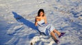 Beautiful girl drinking tea on the snow in winter. Royalty Free Stock Photo