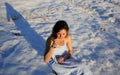 Beautiful girl drinking tea on the snow in winter. Royalty Free Stock Photo