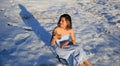 Beautiful girl drinking tea on the snow in winter. Royalty Free Stock Photo