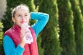 Beautiful girl is drinking water the hot sun in the park Royalty Free Stock Photo
