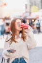 Beautiful girl drinks takeaway coffe while walking Royalty Free Stock Photo