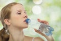 Beautiful girl drinks water from a bottle Royalty Free Stock Photo