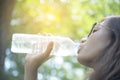 Beautiful girl drinks water from a bottle on the nature Royalty Free Stock Photo