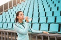 Beautiful girl drinks water from a bottle after sports training Royalty Free Stock Photo