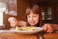 Beautiful girl eating cheesecakes for breakfast. Horizontal image Royalty Free Stock Photo