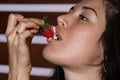 Beautiful girl eating a strawberry