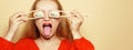 Beautiful girl eating sushi on a white plate. A woman in a red dress and red lips eats sticks of sushi with Philadelphia salmon. Royalty Free Stock Photo