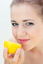 Beautiful girl eats a lemon Royalty Free Stock Photo