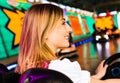 Beautiful girl in an electric bumper car in Royalty Free Stock Photo