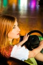 Beautiful girl in an electric bumper car in Royalty Free Stock Photo