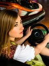 Beautiful girl in an electric bumper car in Royalty Free Stock Photo