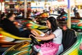 Beautiful girl in an electric bumper car at Royalty Free Stock Photo