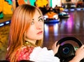 Beautiful girl in an electric bumper car at Royalty Free Stock Photo