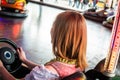 Beautiful girl in an electric bumper car in amusement park Royalty Free Stock Photo