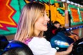 Beautiful girl in an electric bumper car at amusement park Royalty Free Stock Photo