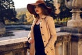 Beautiful girl in elegant fashion clothes posing in autumn park