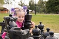 A beautiful girl embraces a large pine tree. figure. The concept of love for chess and strategy. Royalty Free Stock Photo