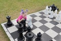 A beautiful girl embraces a large pine tree. figure. The concept of love for chess and strategy Royalty Free Stock Photo