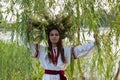 Beautiful girl in embroidery shirt and wreath of wild flowers. Royalty Free Stock Photo