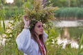 Beautiful girl in embroidery shirt and wreath of wild flowers. Royalty Free Stock Photo