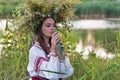 Beautiful girl in embroidery shirt and wreath of wild flowers. Royalty Free Stock Photo