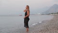 Beautiful girl enjoying the sea at sunrise