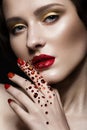 Beautiful girl with evening make-up, red lips in rhinestones and design manicure nails. beauty face. Royalty Free Stock Photo