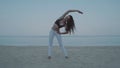 Beautiful girl exercising on the sandy beach Royalty Free Stock Photo