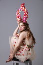 Beautiful girl in a fabulous look with flower horns