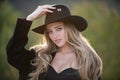 Beautiful girl face closeup, outside portrait of young woman in wide broad brim hat. Summer romantic casual woman. Royalty Free Stock Photo