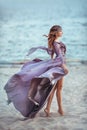 Beautiful Girl In A Fairy Purple Long Dress On A Coast