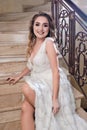 Beautiful girl in fashion dress posing on front staircase Royalty Free Stock Photo