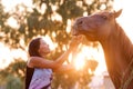 Beautiful girl feeding her handsome horse Royalty Free Stock Photo