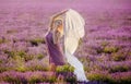 Beautiful girl in a field of lavender on sunset.