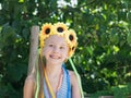 Beautiful girl with floral decoration fun glances to the side. Royalty Free Stock Photo