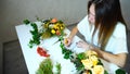 Young female flower handler keeps record of flowers and writes o