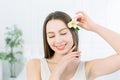Beautiful Girl With Flower near her face, closing eyes. Close-up Beauty Woman Face. Perfect Skin.Body care. Professional Royalty Free Stock Photo