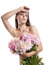 Beautiful girl with flowers peonies. A woman holding a large bouquet of flowers in their hands
