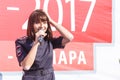 a beautiful girl form a policeman sings in a city park for city dwellers on a sunny day