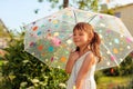 Beautiful girl in garden under the summer rain Royalty Free Stock Photo