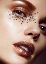 Beautiful girl with a gentle make-up and crystals on the face. Close-up portrait. Royalty Free Stock Photo