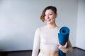 Beautiful girl getting ready for yoga indoors in daylight Royalty Free Stock Photo