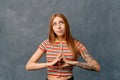 Beautiful girl with ginger hair isolated on wall